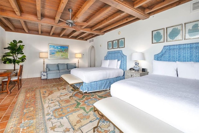 bedroom with beamed ceiling, tile patterned flooring, and wooden ceiling