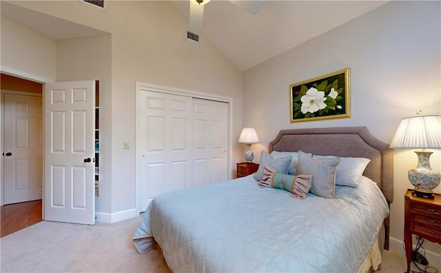 carpeted bedroom featuring ceiling fan, a closet, and high vaulted ceiling