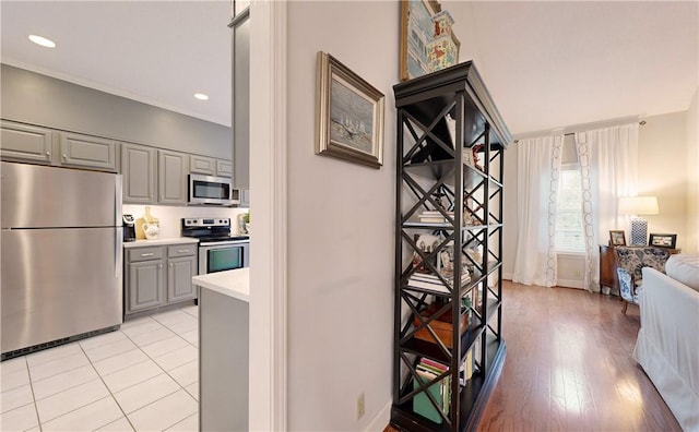 kitchen featuring gray cabinetry, stainless steel appliances, and light hardwood / wood-style flooring