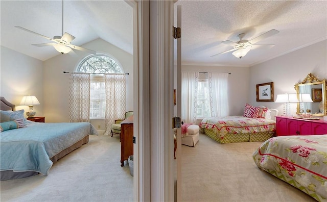 carpeted bedroom featuring a textured ceiling, ceiling fan, crown molding, and vaulted ceiling