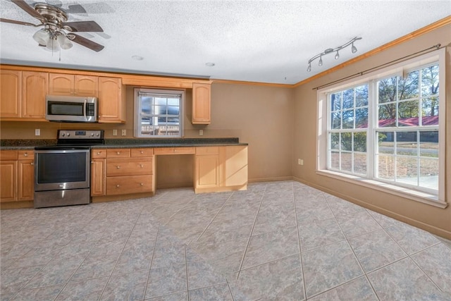 kitchen with light tile patterned floors, ornamental molding, stainless steel appliances, and a textured ceiling