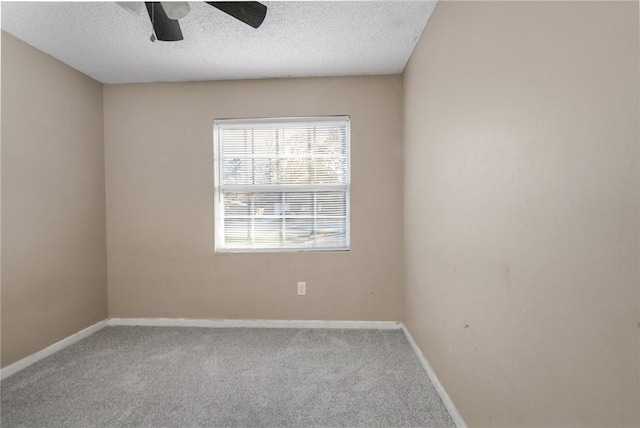 unfurnished room with ceiling fan, carpet floors, and a textured ceiling