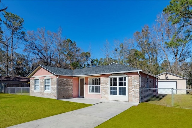 ranch-style home with an outbuilding, a garage, and a front lawn