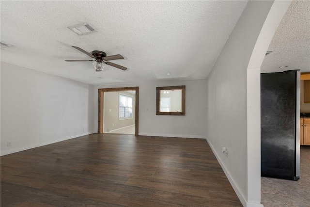 unfurnished living room with dark hardwood / wood-style floors, a textured ceiling, and ceiling fan