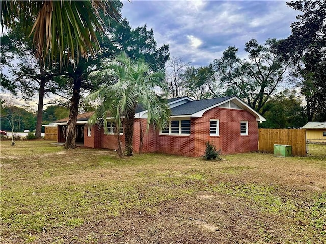 view of property exterior with a lawn