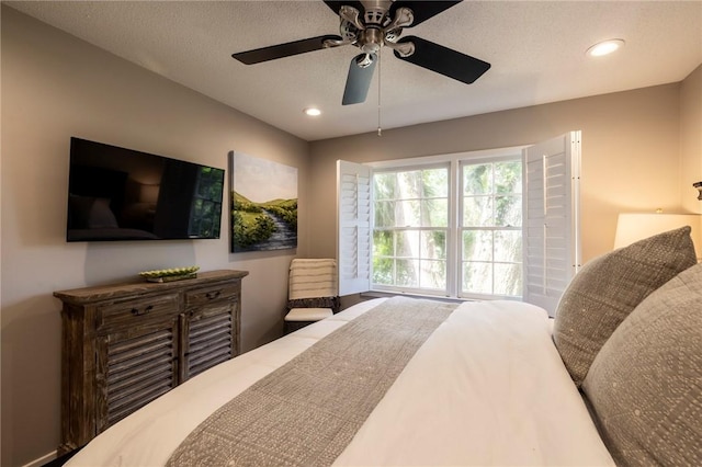 bedroom with a textured ceiling and ceiling fan