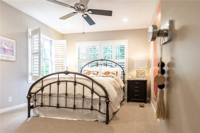 bedroom with ceiling fan and light colored carpet