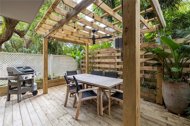 wooden deck with a grill and a pergola