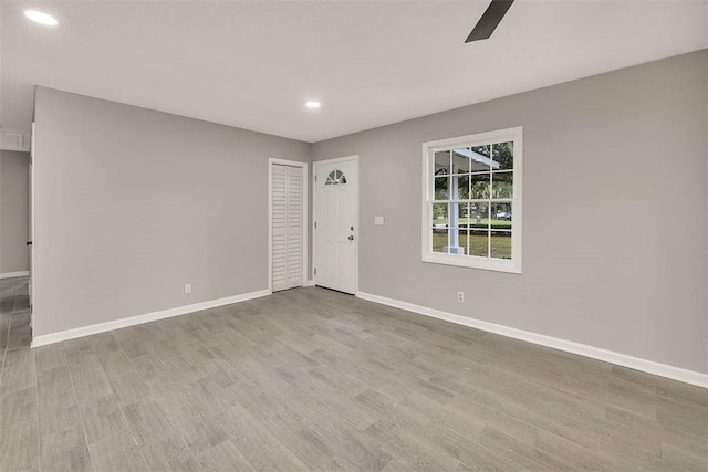 spare room with light hardwood / wood-style floors and ceiling fan