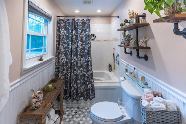 bathroom featuring toilet and shower / bathtub combination with curtain