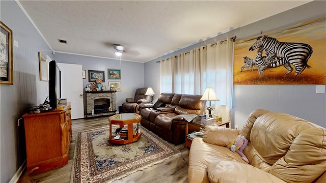 1703 Rainbow Dr, Waycross, GA 31501 - living area with wood finished floors, crown molding, a ceiling fan, and a fireplace
