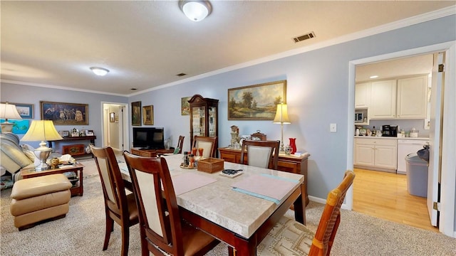 1703 Rainbow Dr, Waycross, GA 31501 - dining area with light carpet and ornamental molding