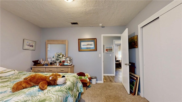 1703 Rainbow Dr, Waycross, GA 31501 - bedroom featuring carpet floors and a textured ceiling