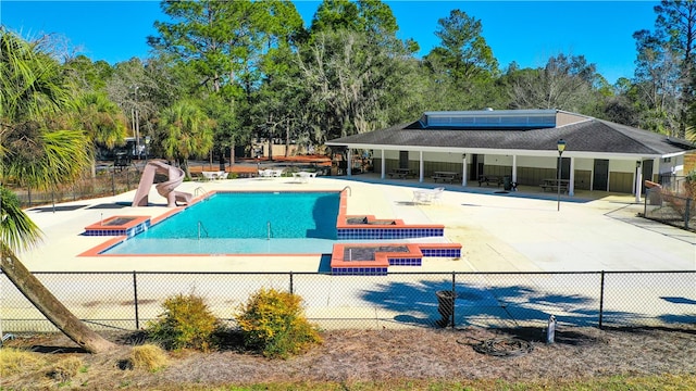 1296 N River Oaks Dr, Blackshear, GA 31516 - community pool with a water slide, a patio, a hot tub, and view of wooded area