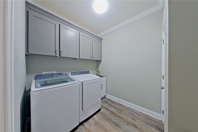 1296 N River Oaks Dr, Blackshear, GA 31516 - washroom with ornamental molding, cabinet space, separate washer and dryer, light wood-style flooring, and a textured ceiling