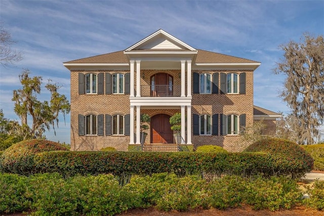 neoclassical / greek revival house featuring a balcony