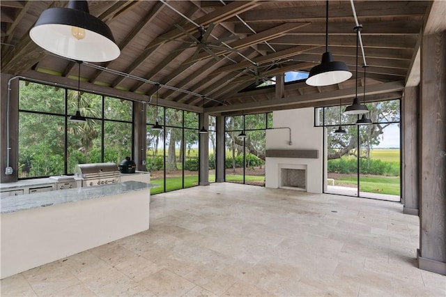 unfurnished sunroom featuring vaulted ceiling with beams and wood ceiling