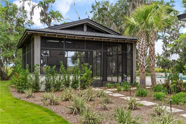 exterior space featuring a pool and a sunroom