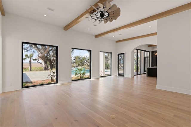 unfurnished living room featuring ceiling fan, beam ceiling, and light hardwood / wood-style floors