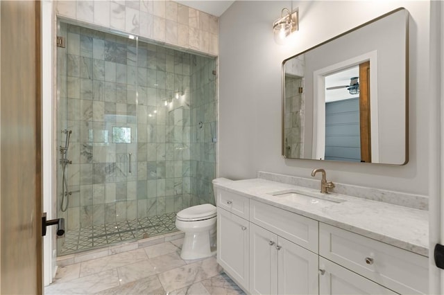 bathroom featuring vanity, toilet, and a shower with shower door