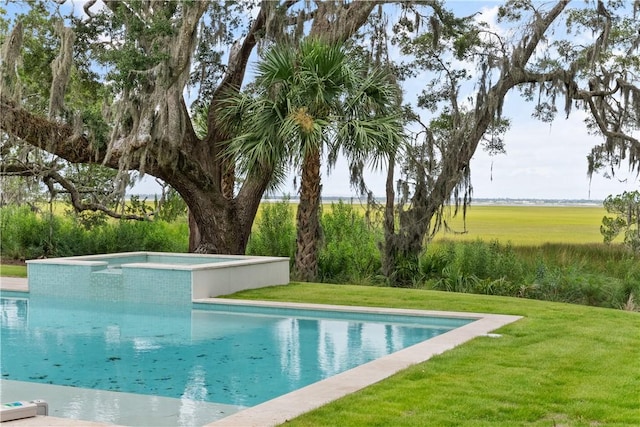 view of pool with a lawn