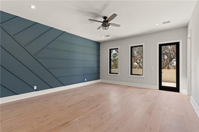 unfurnished room with ceiling fan and light wood-type flooring