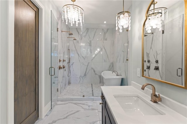 bathroom with a notable chandelier, vanity, a shower with shower door, and tile walls