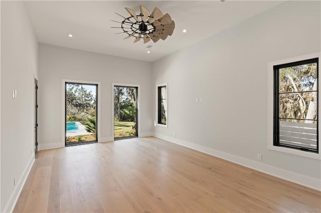 spare room with ceiling fan and light hardwood / wood-style flooring