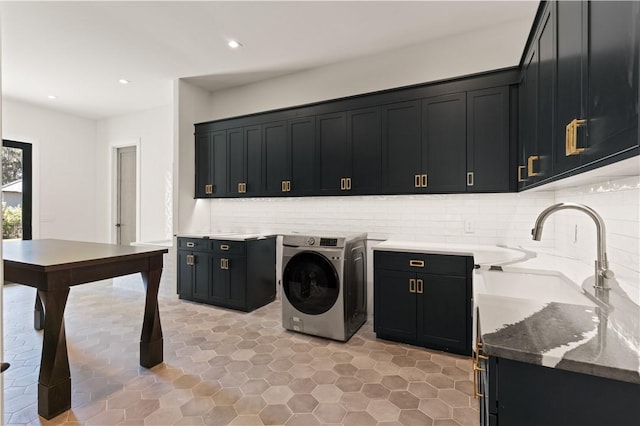 laundry area featuring cabinets, washer / dryer, and sink