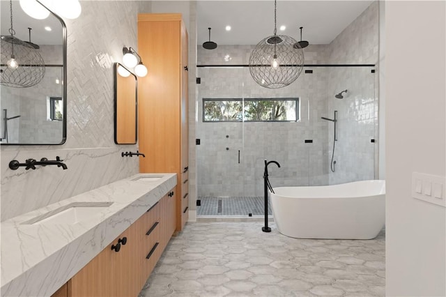 bathroom featuring separate shower and tub, vanity, tile walls, and a notable chandelier