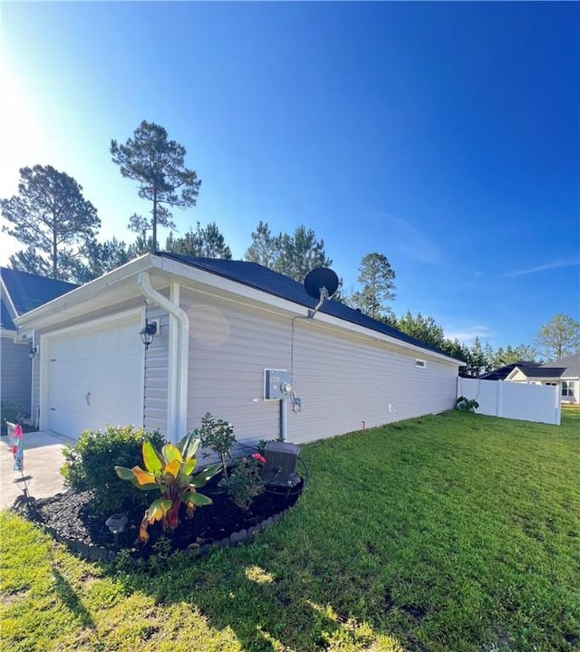 10003 Woodland Cv, Brunswick, GA 31525 - view of side of property featuring an attached garage and concrete driveway