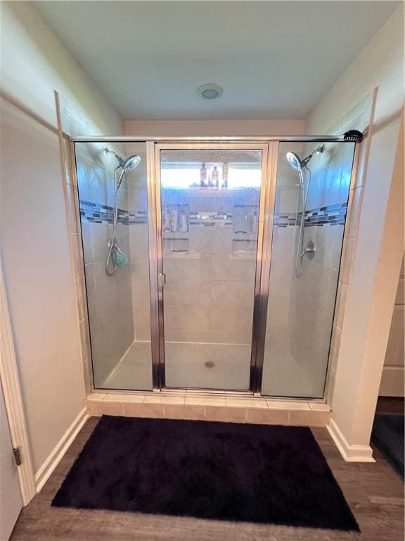 10003 Woodland Cv, Brunswick, GA 31525 - full bath featuring a shower stall and wood finished floors