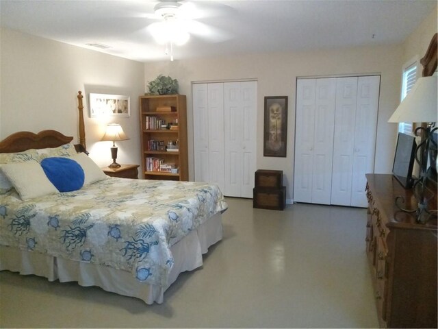 685 Chapel Crossing Rd, Brunswick, GA 31525 - bedroom with two closets, finished concrete flooring, and a ceiling fan