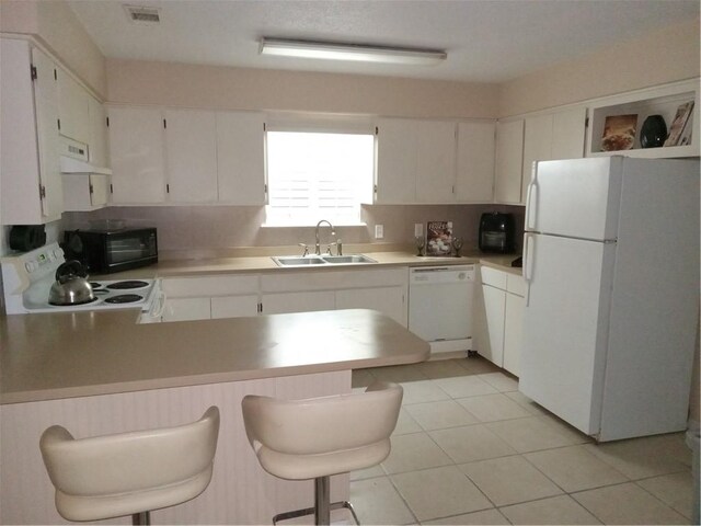 685 Chapel Crossing Rd, Brunswick, GA 31525 - kitchen with white appliances, extractor fan, a peninsula, light tile patterned floors, and light countertops