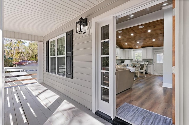 wooden terrace with sink and covered porch