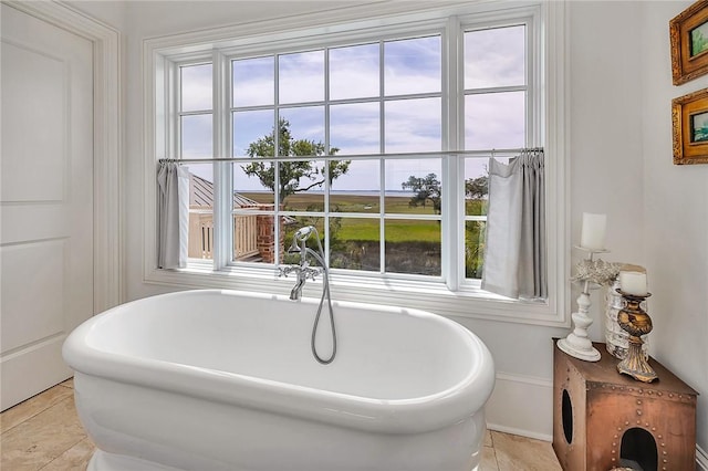 bathroom with tile patterned floors and a bathtub