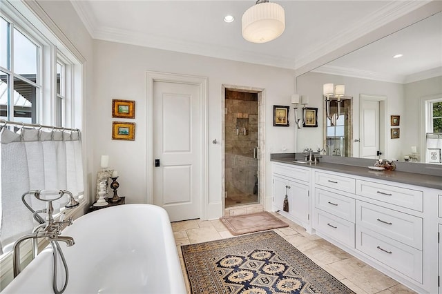 bathroom featuring vanity, ornamental molding, and independent shower and bath