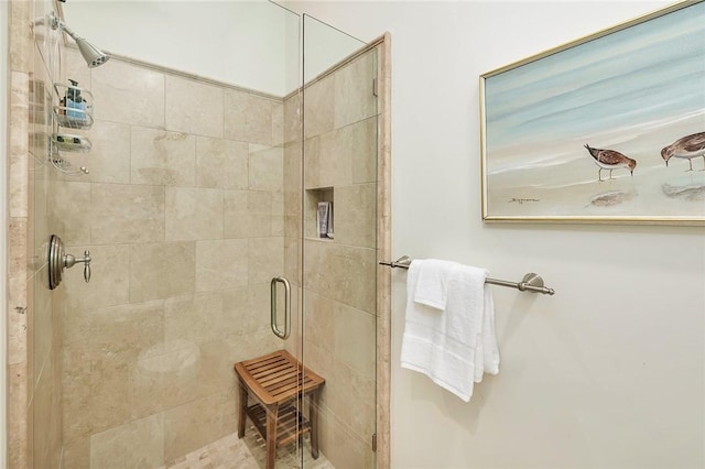 bathroom featuring a shower with door