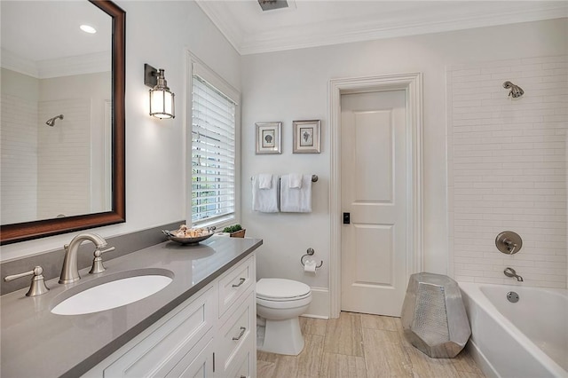 full bathroom with vanity, tiled shower / bath combo, toilet, and crown molding