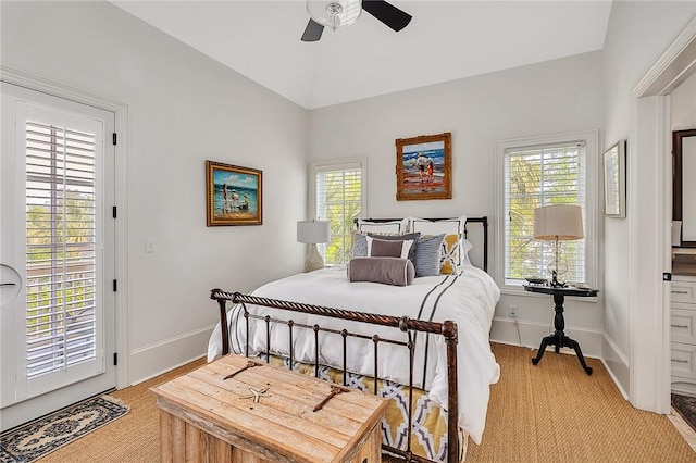 carpeted bedroom with multiple windows, ceiling fan, and access to exterior