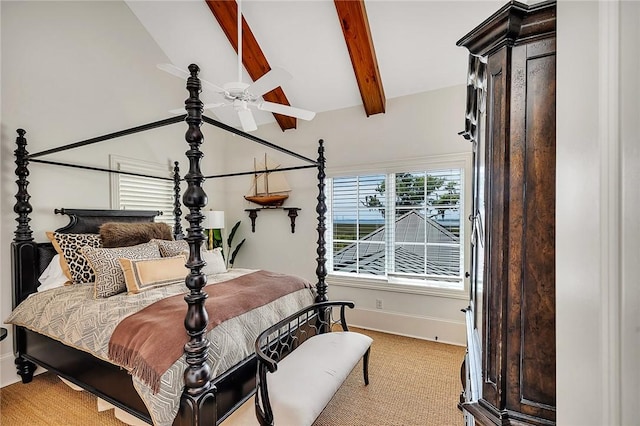 carpeted bedroom with ceiling fan and lofted ceiling with beams