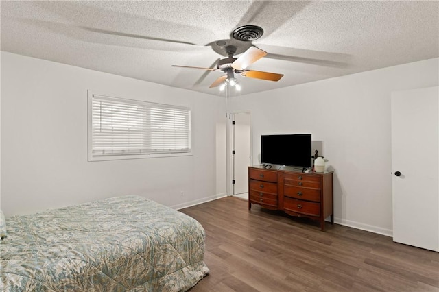 165 Pine Cir, Brunswick, GA 31520 - bedroom featuring wood finished floors, a textured ceiling, and a ceiling fan