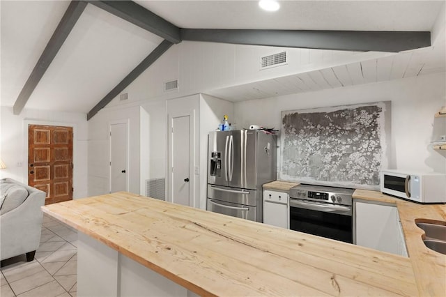 165 Pine Cir, Brunswick, GA 31520 - kitchen featuring stainless steel fridge, white microwave, wall oven, wood counters, and light tile patterned floors