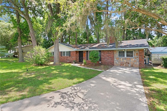 165 Pine Cir, Brunswick, GA 31520 - ranch-style home featuring concrete driveway, a front yard, a chimney, and stone siding