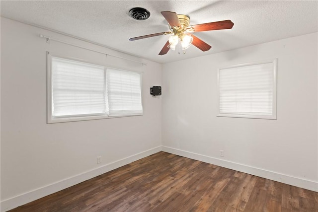 165 Pine Cir, Brunswick, GA 31520 - spare room with dark wood-style floors, a ceiling fan, and a textured ceiling