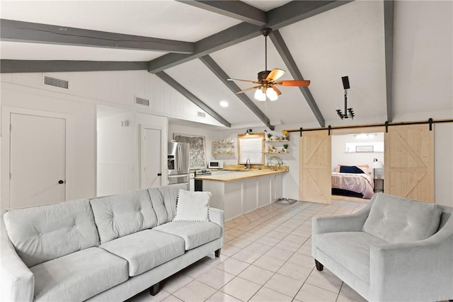 165 Pine Cir, Brunswick, GA 31520 - living room featuring a barn door, light tile patterned flooring, and ceiling fan