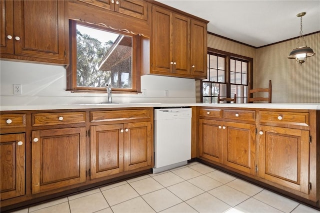 kitchen featuring sink, white dishwasher, hanging light fixtures, and light tile patterned floors