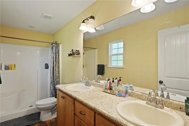 76 Red Gate Rd, Waynesville, GA 31566 - bathroom featuring a shower with curtain, double vanity, and wood finished floors