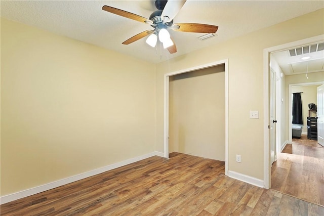 76 Red Gate Rd, Waynesville, GA 31566 - unfurnished bedroom featuring attic access, wood finished floors, a closet, and ceiling fan