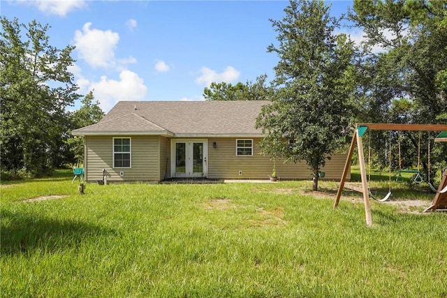 76 Red Gate Rd, Waynesville, GA 31566 - rear view of house with french doors, a playground, and a yard